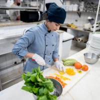 chef chopping vegetables in a commercial kitchen - food stock pictures, royalty-free photos & images