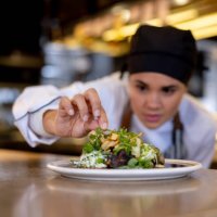 chef decorating a plate while working at a commercial kitchen - food stock pictures, royalty-free photos & images