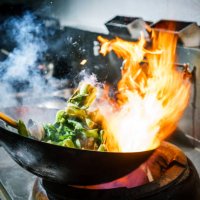 chef in restaurant kitchen at stove with high burning flames - food stock pictures, royalty-free photos & images