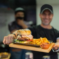 chef of a fast food restaurant proudly show the food they cooked - junk food stock pictures, royalty-free photos & images