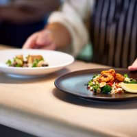 chef placing dishes of prepared food on counter - food stock pictures, royalty-free photos & images