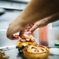 chef preparing a cheeseburger - junk food stock pictures, royalty-free photos & images
