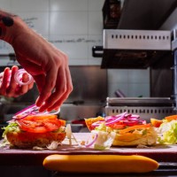 chef preparing hamburgers in a restaurant - junk food stock pictures, royalty-free photos & images