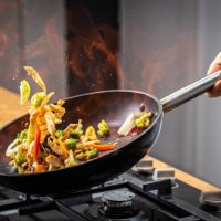 chef tossing flaming vegetable - food stock pictures, royalty-free photos & images