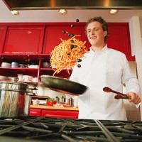 chef tossing spaghetti and olives from pan - food stock pictures, royalty-free photos & images