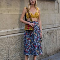 Chiara Ferragni wearing a golden cropped top, skirt with floral print and Prada bag is seen outside Prada during Milan Men's Fashion Week...