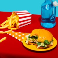 chicken burger and french fries with soda bottle on table against blue background - junk food stock pictures, royalty-free photos & images
