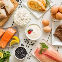 chicken meat, fish, cottage cheese, yogurt and eggs on white table - food photos et images de collection