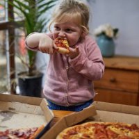 child eating a slice of pizza - junk food stock pictures, royalty-free photos & images