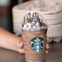 child hand holding a coffee frappuccino - junk food stock pictures, royalty-free photos & images