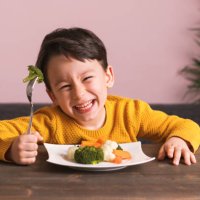 child is eating vegetables. - food stock pictures, royalty-free photos & images