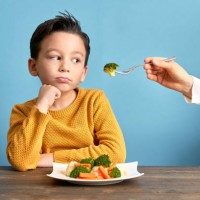 child is very unhappy with having to eat vegetables. - food stock pictures, royalty-free photos & images