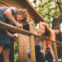 childhood friends hammering and working to build their treehouse - home decoration stock pictures, royalty-free photos & images