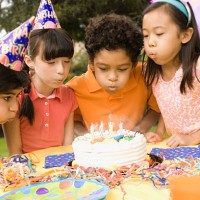 children blowing out candles on birthday cake - garden decoration stock pictures, royalty-free photos & images