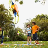 children hitting pinata at birthday party - garden decoration stock pictures, royalty-free photos & images