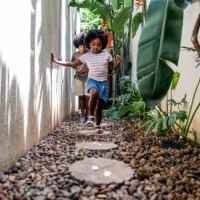 children hunting easter eggs at home - garden decoration stock pictures, royalty-free photos & images