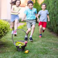 children running towards an easter basket on the ground - garden decoration stock pictures, royalty-free photos & images