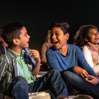 children talking and laughing at the outdoors cinema - concert stock pictures, royalty-free photos & images