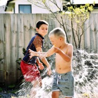 children water bomb fighting - garden decoration stock pictures, royalty-free photos & images