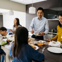 chinese family of four eating takeout food for evening meal - junk food stock pictures, royalty-free photos & images