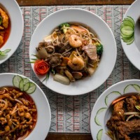 chinese food on plates in restaurant - junk food stock pictures, royalty-free photos & images