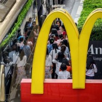 Chinese tourists board their bus in front of a McDonald's restaurant in Bangkok on January 30, 2020. Thailand has detected 14 cases so far of the...