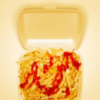 chips covered with ketchup in take out box, overhead view - junk food stock pictures, royalty-free photos & images