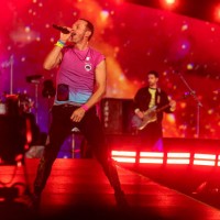 Chris Martin, Guy Berryman and Will Champion of Coldplay perform live on stage at Parken Stadium on July 5, 2023 in Copenhagen, Denmark.