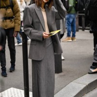 Christine Centenera is seen wearing a gray suit and black sunglasses outside the Miu Miu show during the Womenswear Fall/Winter 2025/2026 as part of...