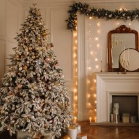 christmas concept. festive christmas rich interior in a luxurious modern style with a fireplace and decorated with christmas balls and garlands of christmas trees in a large bright living room in the apartment on new year's e
