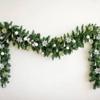 christmas garland with a christmas tree on a white wall. new year's decor. minimalism. festive background. - home decoration stock pictures, royalty-free photos & images