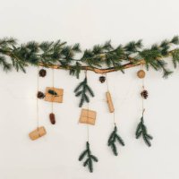 christmas tree branch with a garland and gifts on the wall. new year. christmas. christmas decor. christmas tree. christmas background. holiday. - home decoration stock pictures, royalty-free photos & images