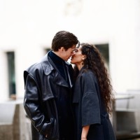 Ciinderella B wears a gray long coat ; Mathias Le Fevre wears a black leather long coat and a turtleneck pullover, outside Rokh, during Paris Fashion...