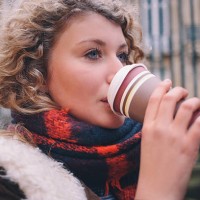 city student sipping a takeaway coffee on a winter day - junk food stock pictures, royalty-free photos & images