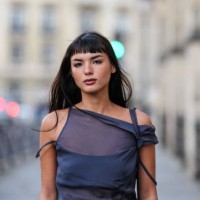 Clara Kong Vila wears short bangs long hair, dark navy blue sheer mesh sleeveless top, outside Paloma Wool, during the Paris Fashion week Women's...