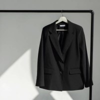 classic black jacket hanging on the shoulder on a rail. - fashion stock pictures, royalty-free photos & images