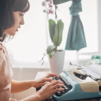 classy woman using typewriter - home decoration stock-fotos und bilder