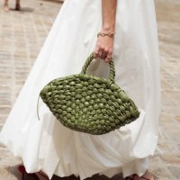 Clelia Montali wears a long white maxi dress, and army green bag outside Peet Dullaert during the Haute Couture Fall/Winter 2024/2025 as part of...