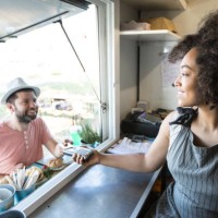 client using credit card for payment in food van - junk food stock pictures, royalty-free photos & images