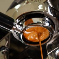 close-up and a tight shot of pulling espresso and crema being extracted from a portafilter. - coffee stock pictures, royalty-free photos & images