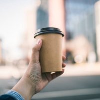 close-up of a businessman holding recycable takeaway coffee cup - junk food stock pictures, royalty-free photos & images