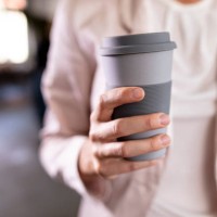 close-up of a businesswoman holding recycable takeaway coffee cup - junk food stock pictures, royalty-free photos & images