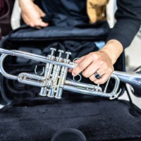 close-up of a human hand holding a trumpet in the backstage of the music concert - concert stock pictures, royalty-free photos & images