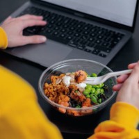 close-up of a person eating a healthy lunch in a plastic container. lunch at work. - junk food stock pictures, royalty-free photos & images