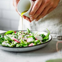 close-up of a woman preparing healthy summer green salad at home kitchen - food stock pictures, royalty-free photos & images
