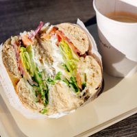 close-up of bagel with salmon and cream cheese and coffee - junk food stock pictures, royalty-free photos & images