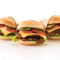 close-up of burgers against white background - junk food stock pictures, royalty-free photos & images