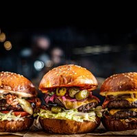 close-up of burgers on table - junk food stock pictures, royalty-free photos & images