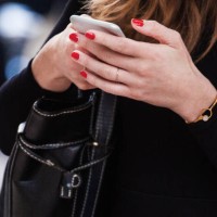 close-up of female hands in diamond jewelry hold a phone in expensive rim - fashion week stock pictures, royalty-free photos & images