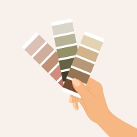 close-up of hand holding color swatches against wall. comparing paint options for interior design or renovation - home decoration stock illustrations